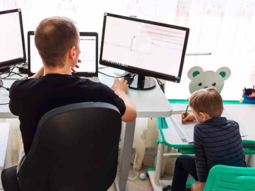 man working from home with son working beside him.