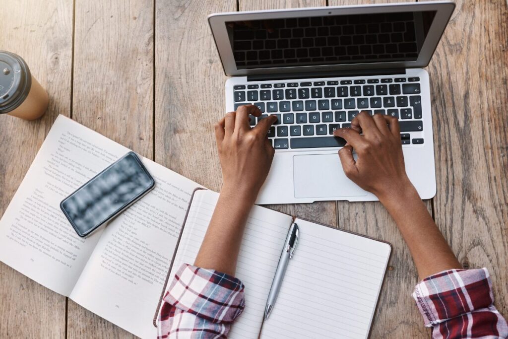 woman sitting at computer typing.