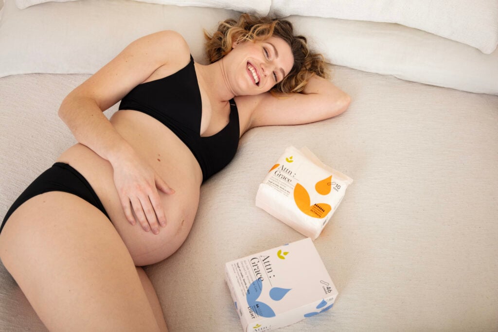 pregnant woman with attention grace products next to her.