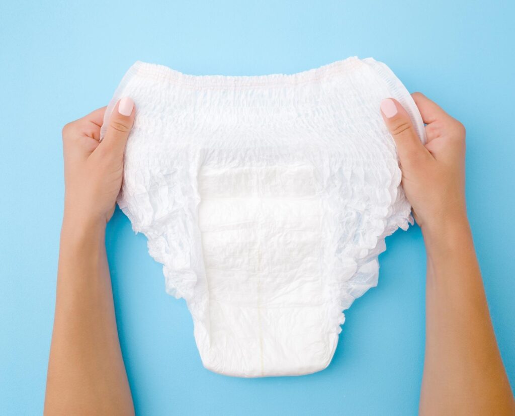 woman holding adult absorbent brief.