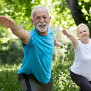 man and woman with arms spread in the outdoors.