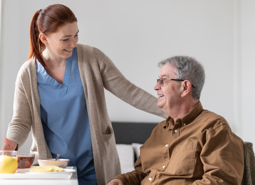 nurse standing helping a patient.