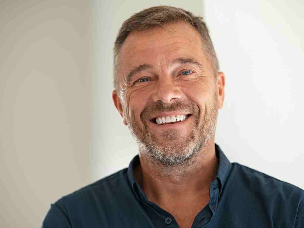 man looking at camera smiling.