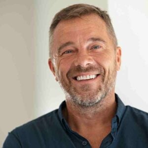 man looking at camera smiling.
