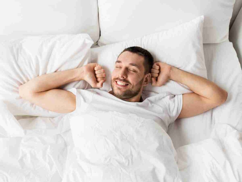 man in bed stretching. | Do frequent ejaculations reduce the risk of prostate cancer?