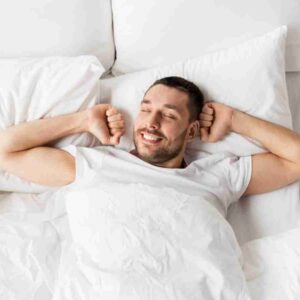 man in bed stretching. | Do frequent ejaculations reduce the risk of prostate cancer?