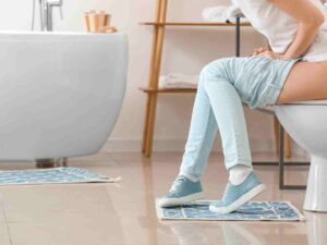 woman sitting on toilet.