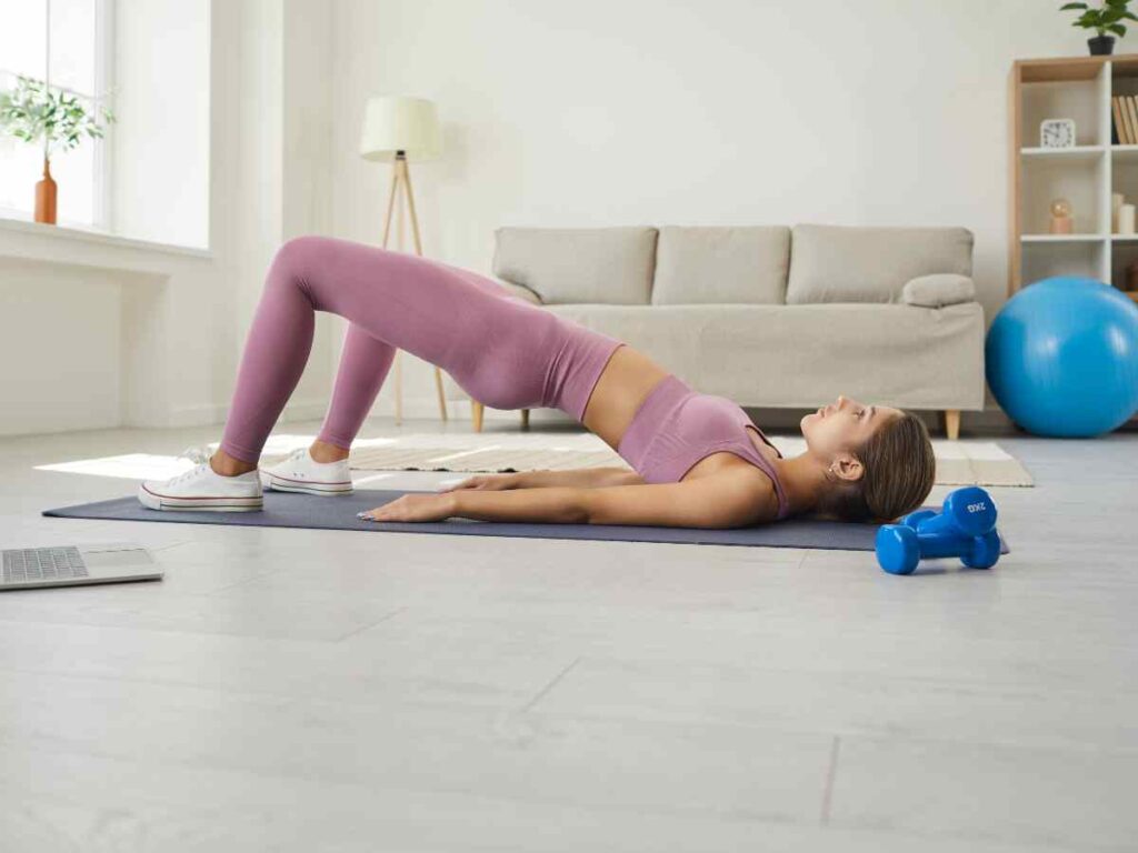 woman doing pelvic floor exercises on the floor.