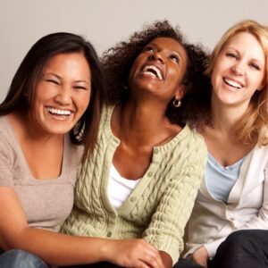 group of women smiling looking at camera.