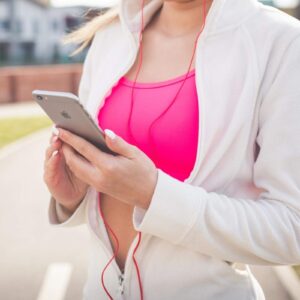 woman holding phone, exercising.