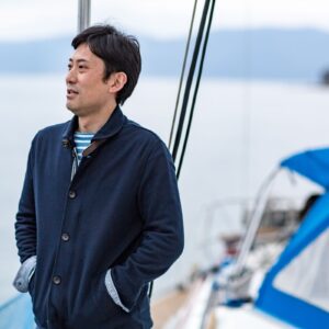 man on boat looking out at water.
