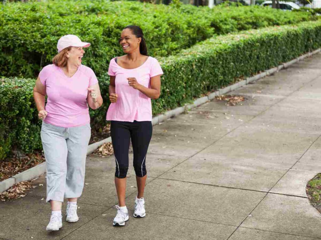 two women walking outside.