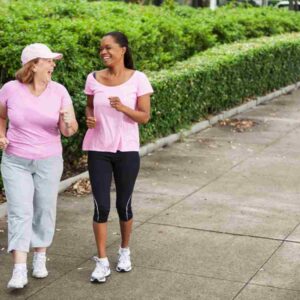 two women walking outside.