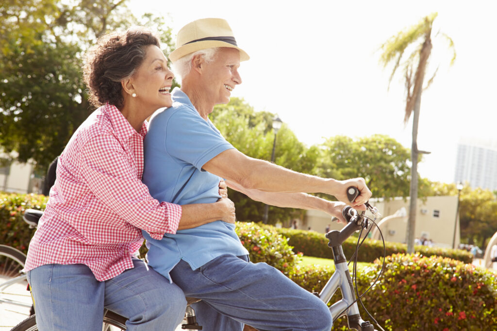 man and woman riding bike.