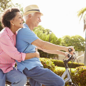 man and woman riding bike.