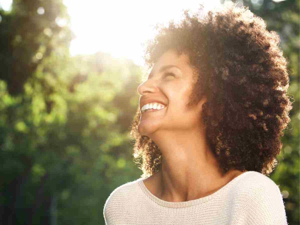 woman outside smiling.